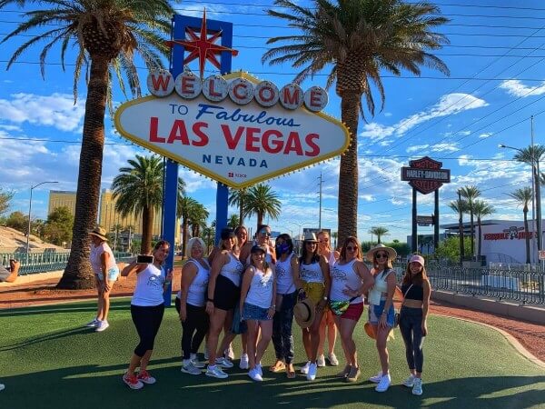 Ladies posing in front of the Welcome to Las Vegas sign